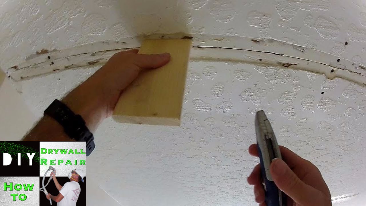 Fire-damaged drywall being inspected and prepared for professional replacement