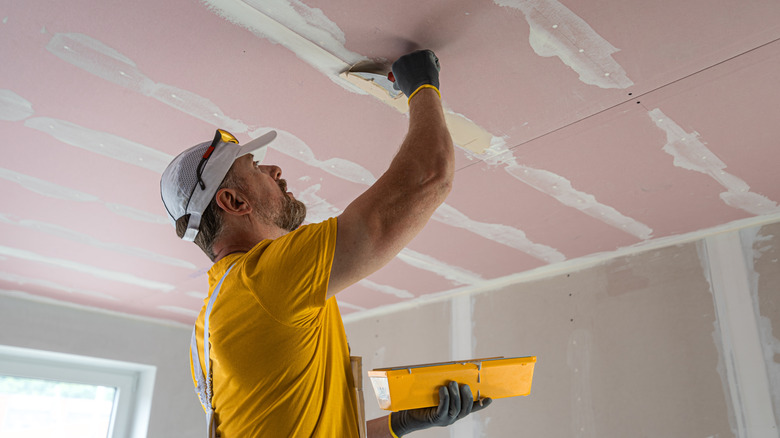 Homeowner preparing for a professional drywall installation project